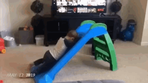 a child is playing on a slide in a living room on may 12 2019 .