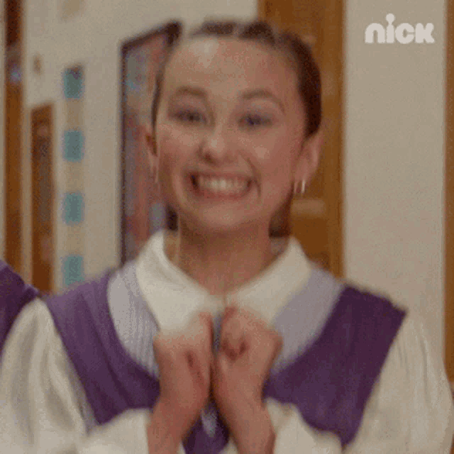 a girl in a purple vest is smiling with a nick logo in the corner