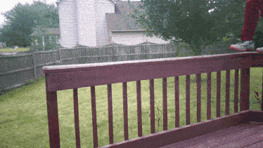 a person is jumping over a wooden deck railing