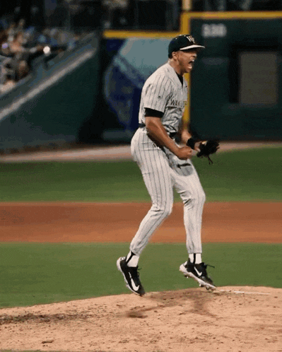 a man in a new york yankees uniform is standing on the mound