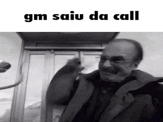 a black and white photo of a man in a phone booth with the words gm saiu da call on the bottom .