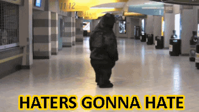 a sign that says haters gonna hate with a picture of a bear