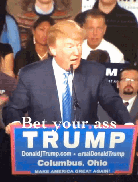 donald trump holds a sign that says bet your ass trump columbus ohio