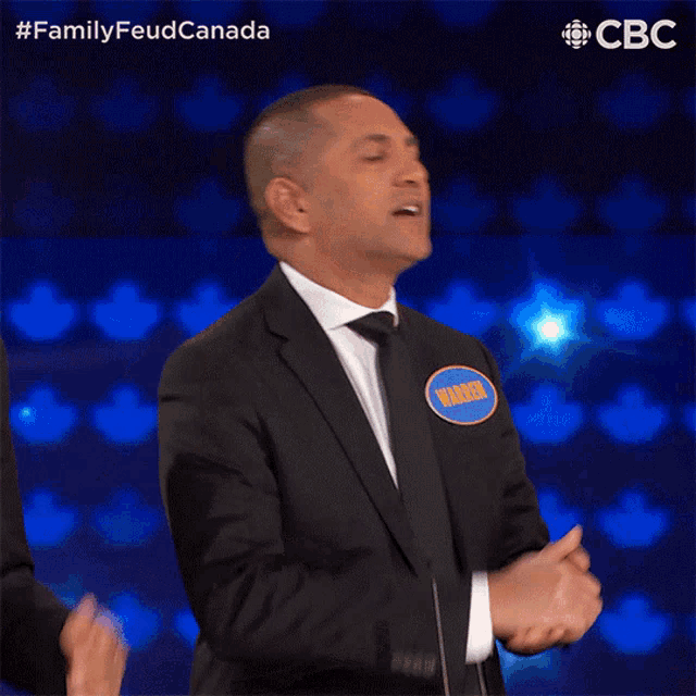 a man in a suit with a name tag that says vince