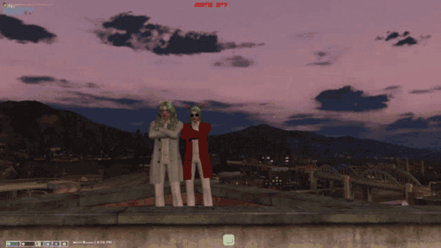 two people standing on top of a building with a screen that says empire city
