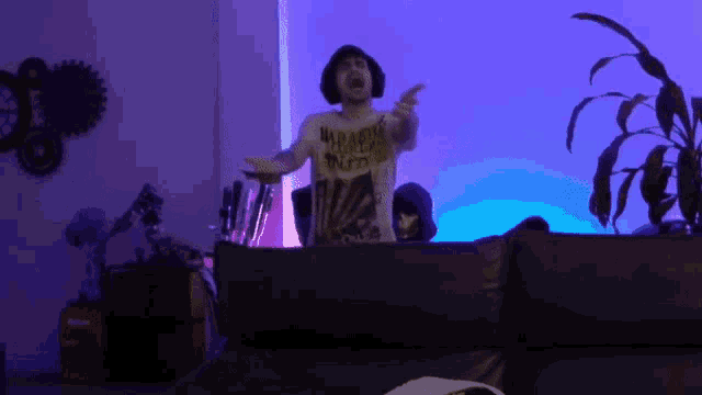 a man wearing a t-shirt that says ' weapons ' on it