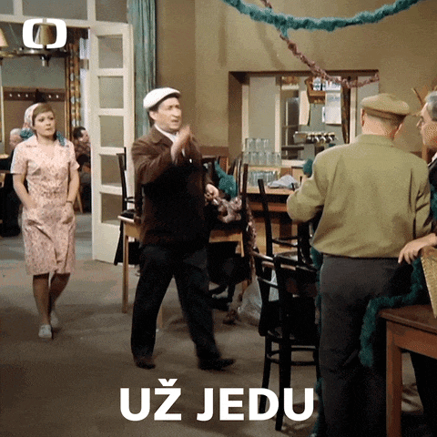 a group of people standing in a room with the word uz jedu written on the bottom