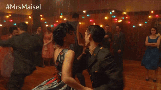 a man in a military uniform is kissing a woman on the cheek at a party with the hashtag #mrsmaisel