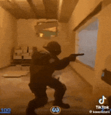 a man is holding a gun in a video game while standing in front of a window .