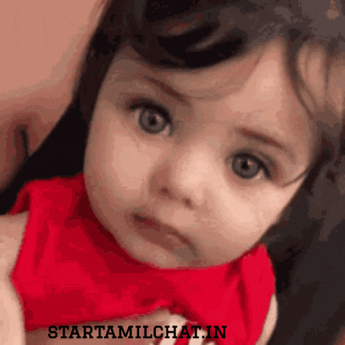 a baby in a red shirt with the words starttamilchat.in written below it