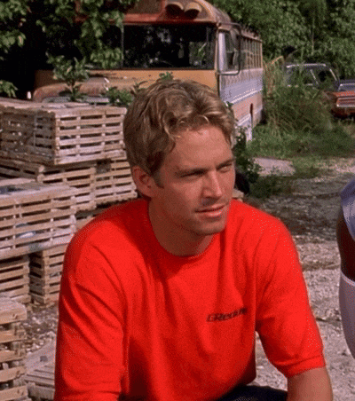 a man wearing a red t-shirt with the word greddy on it
