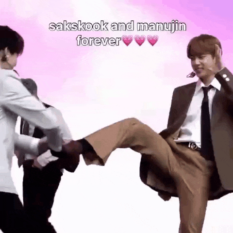 a man in a suit and tie is kicking another man 's leg in the air .