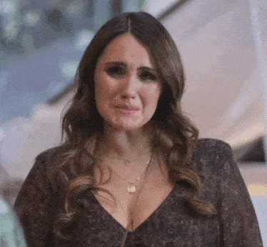 a woman wearing a necklace with the letter o on it