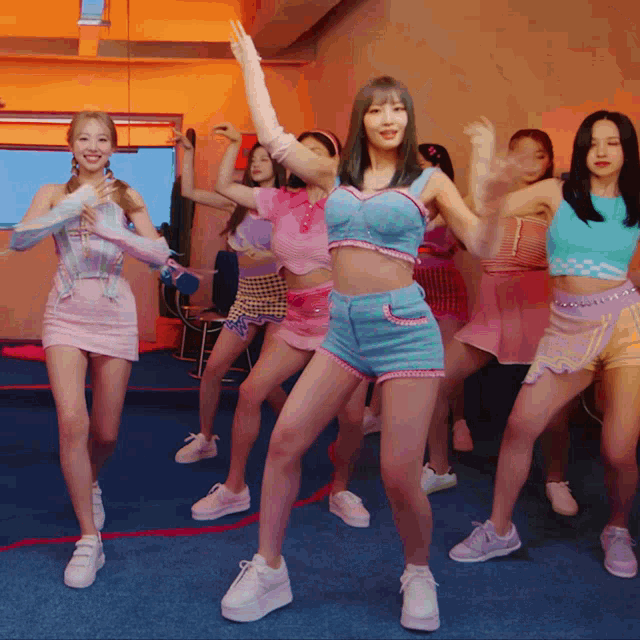 a group of women are dancing in a room