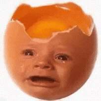 a broken egg with a baby 's face in it