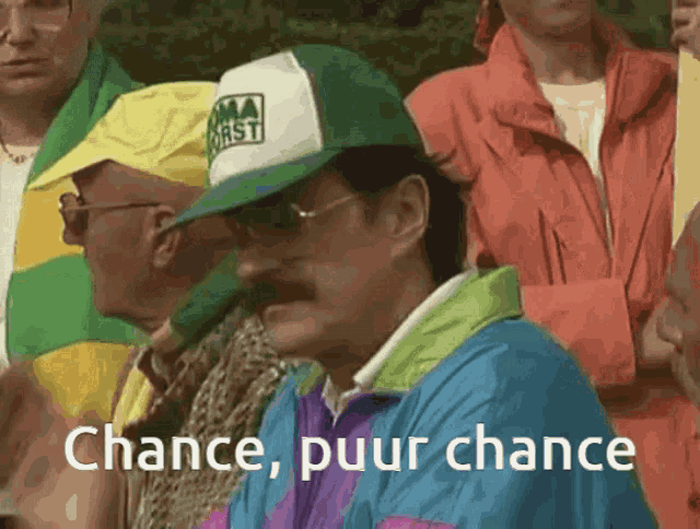 a man wearing a green and white hat says chance , puur chance