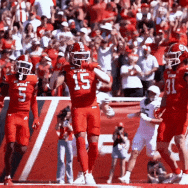 a football player in a red uniform with the number 15 on his jersey