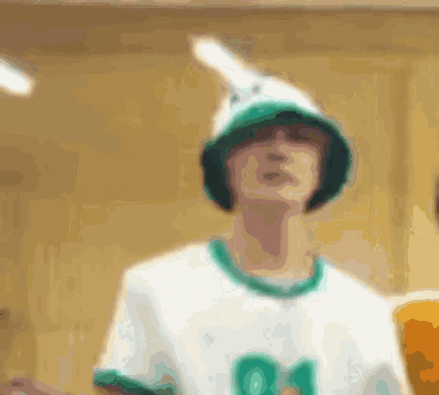 a blurry picture of a person wearing a green hat and a white shirt with the number 04 on it