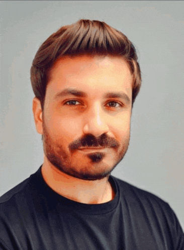 a man with a beard wears a black shirt