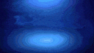 a whale is swimming in the ocean with a light coming out of its mouth