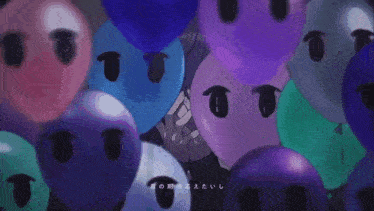 a bunch of balloons with faces on them with chinese writing on the bottom