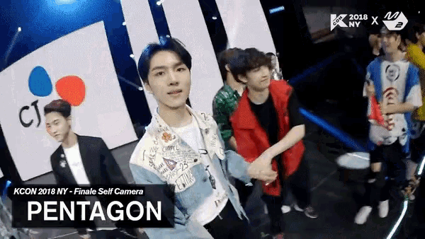 a group of young men are standing on a stage with the name pentagon on the bottom