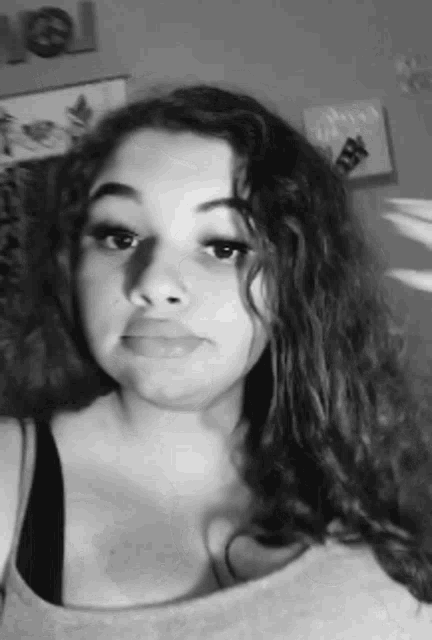 a black and white photo of a woman with long curly hair