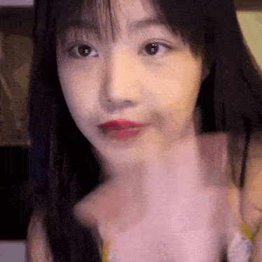 a close up of a woman 's face with a blurred background .