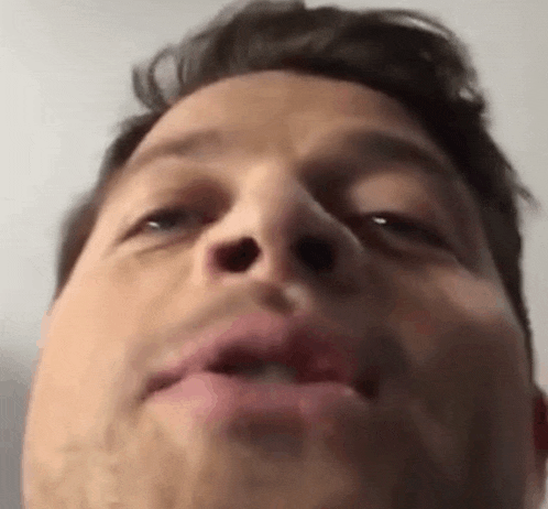 a close up of a man 's face with his mouth open and his nose visible .