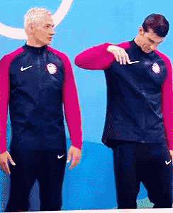 two men are standing next to each other and one has a nike logo on his shirt