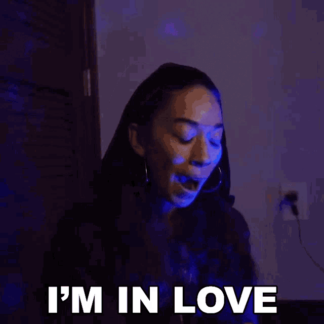 a woman is smiling and says i 'm in love