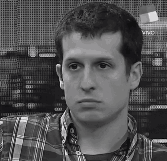 a man in a plaid shirt stands in front of a screen that says " vivo " on it