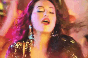 a woman in a sequined top is dancing in a club