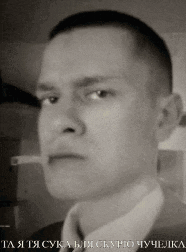 a black and white photo of a man in a suit