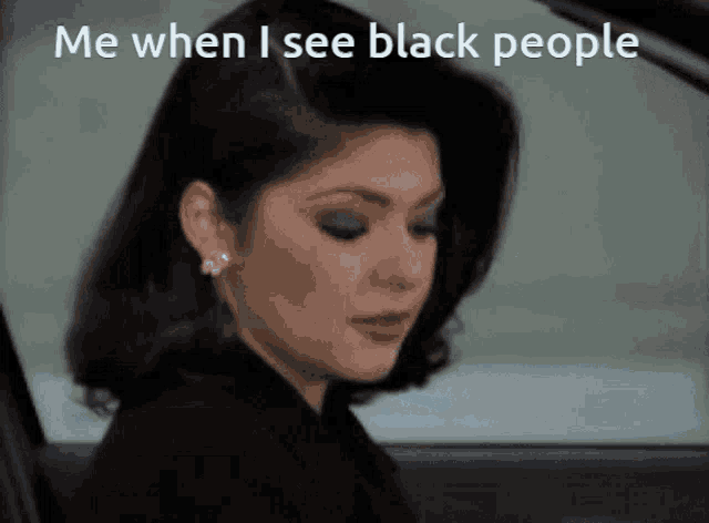 a woman is sitting in a car with the words me when i see black people above her
