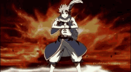 a fairy tail character is standing in front of a fire explosion .