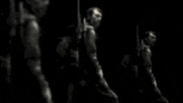 a man in a gas mask is holding a large knife