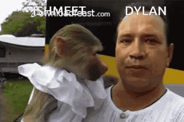 a man is holding a monkey in his arms and the monkey is wearing a white shirt