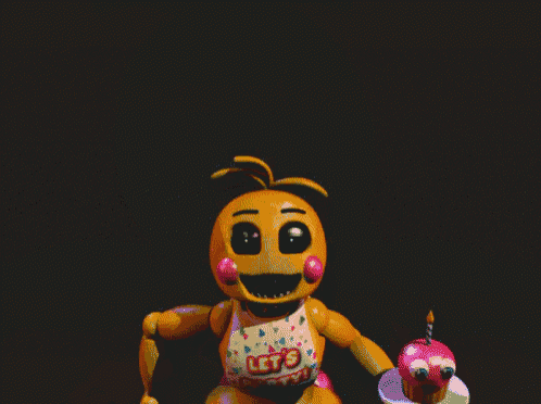 a yellow teddy bear with pink cheeks and teeth is smiling