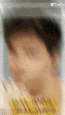 a blurry picture of a person 's face with the capcut logo in the corner