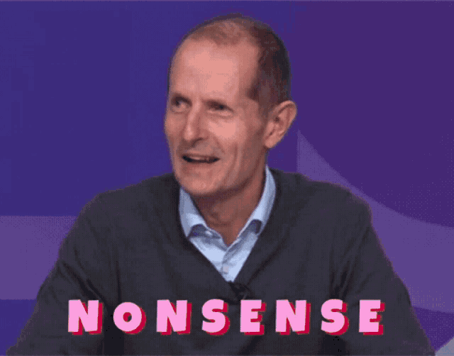 a man in a grey sweater is sitting in front of a purple background that says " nonsense "