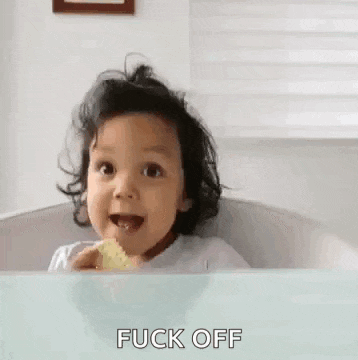 a little girl is sitting in a high chair eating chips and making a face .