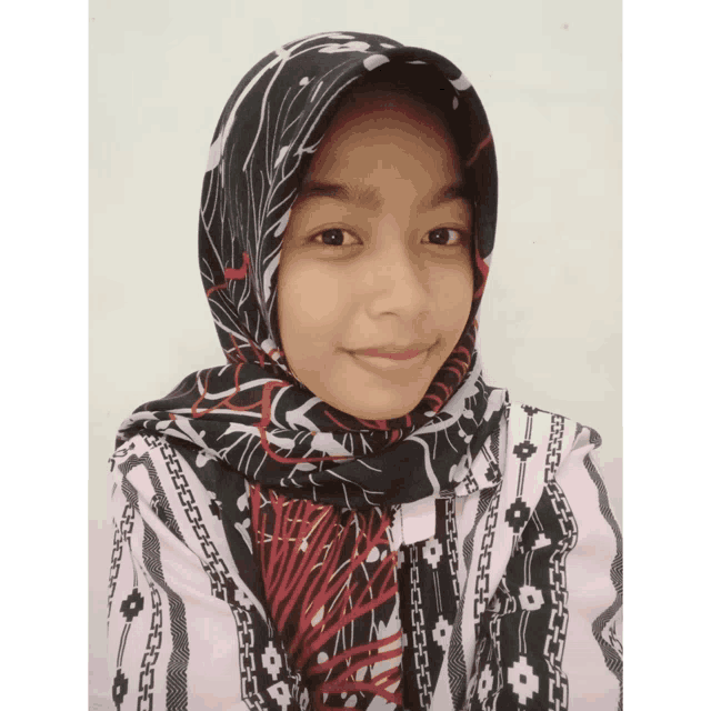 a woman wearing a black and white scarf and a pink shirt