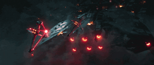 a helicopter is flying through the air with a red light behind it