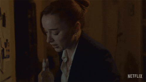a woman drinking from a bottle with a netflix logo on the bottom