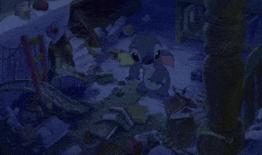 a cartoon character named stitch is sitting in a messy room