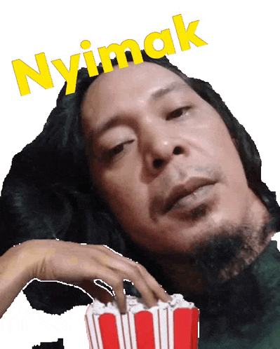 a man with long hair and a beard is holding a bucket of popcorn and the word nyimak is above him