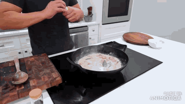 a man cooking on a stove with the words made in animatica on the bottom of the screen