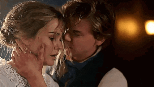 a man and a woman are kissing each other on the forehead .