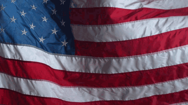 a red white and blue american flag with white stars on it